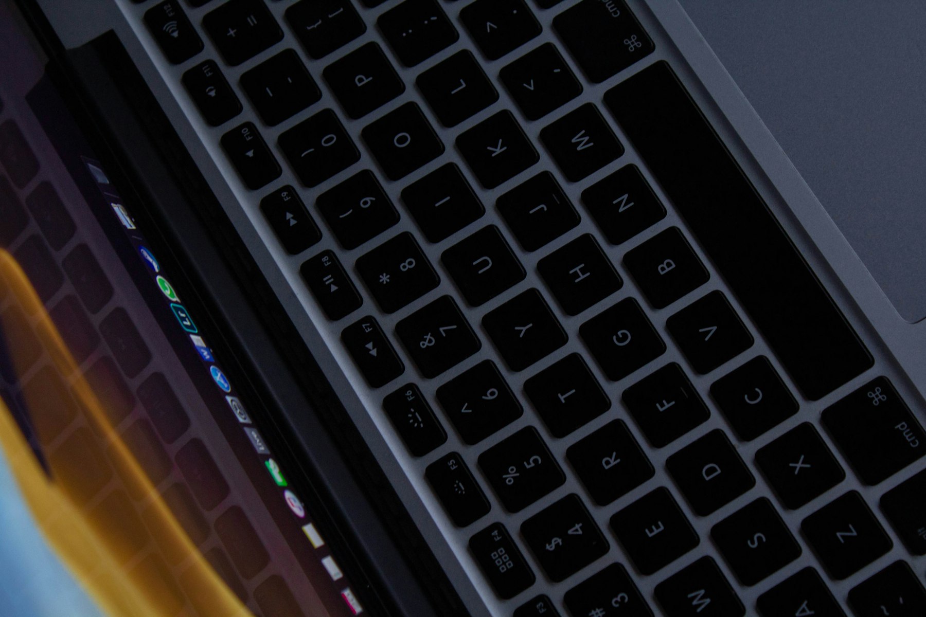 A laptop keyboard seen at an angle in low light